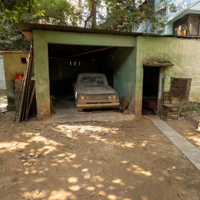 The Unused Garage With An Old Car Of The Owner